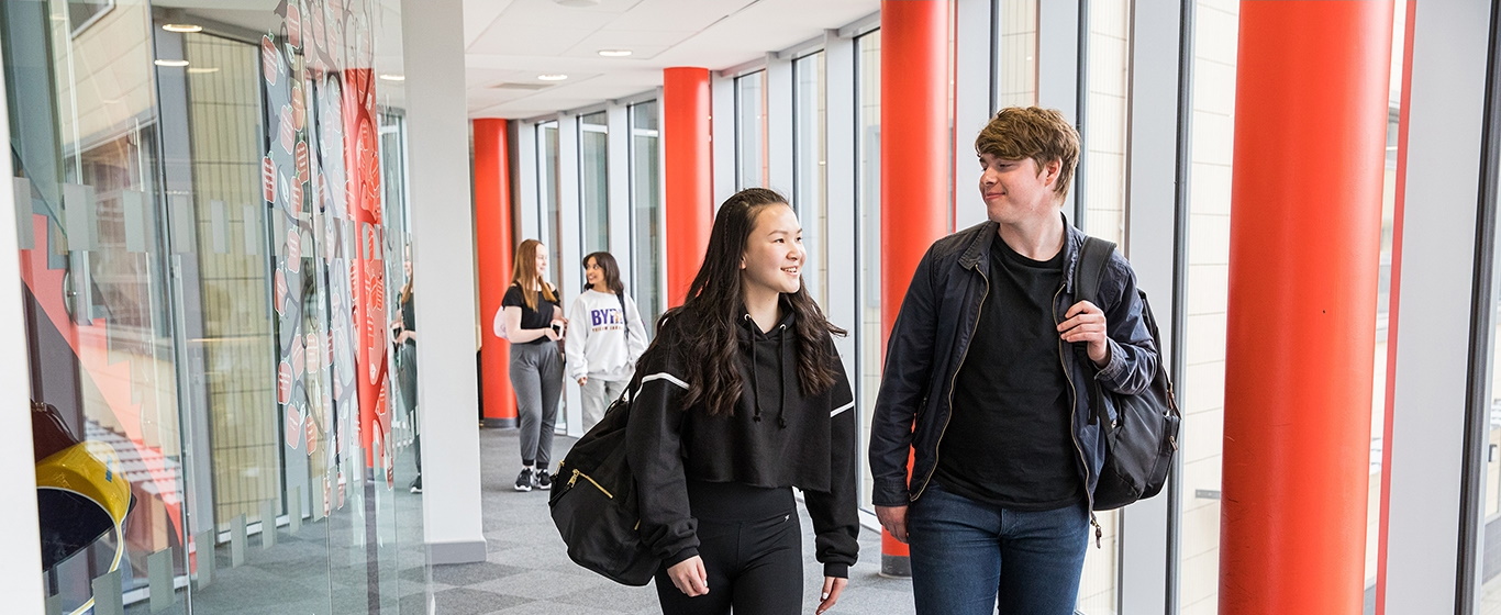 Two students walking through the corridors at Booth Lane.